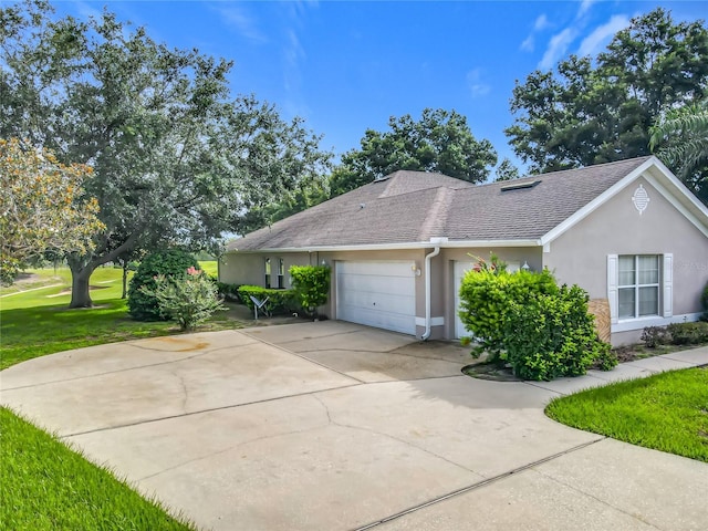36730 Oconee Ave, Eustis, FL 32736 - view of front of property with a shingled roof, stucco siding, a front yard, a garage, and driveway