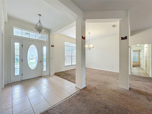 36730 Oconee Ave, Eustis, FL 32736 - entryway featuring light carpet, plenty of natural light, a chandelier, and light tile patterned floors