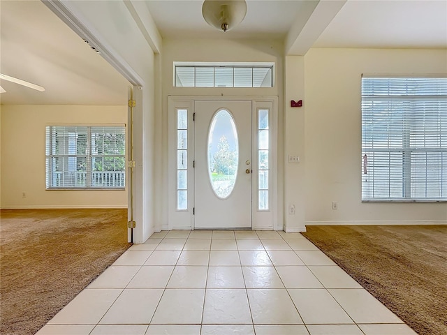 36730 Oconee Ave, Eustis, FL 32736 - entrance foyer featuring light colored carpet, light tile patterned floors, and ceiling fan