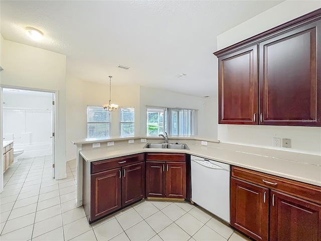 36730 Oconee Ave, Eustis, FL 32736 - kitchen with white dishwasher, a chandelier, reddish brown cabinets, and light countertops