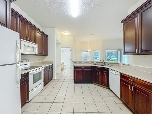 36730 Oconee Ave, Eustis, FL 32736 - kitchen featuring white appliances, light countertops, a textured ceiling, a chandelier, and light tile patterned flooring