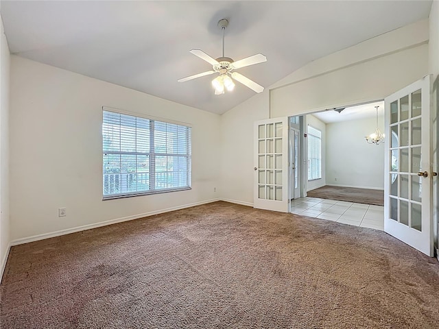 36730 Oconee Ave, Eustis, FL 32736 - tiled spare room featuring french doors, carpet flooring, lofted ceiling, a chandelier, and a ceiling fan