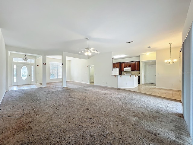 36730 Oconee Ave, Eustis, FL 32736 - unfurnished living room featuring light carpet, ceiling fan, a chandelier, and light tile patterned floors