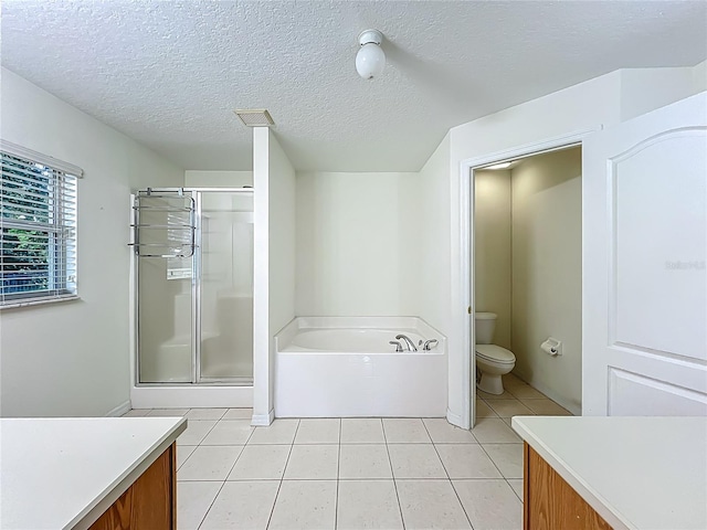 36730 Oconee Ave, Eustis, FL 32736 - full bathroom featuring a garden tub, tile patterned floors, vanity, a stall shower, and a textured ceiling
