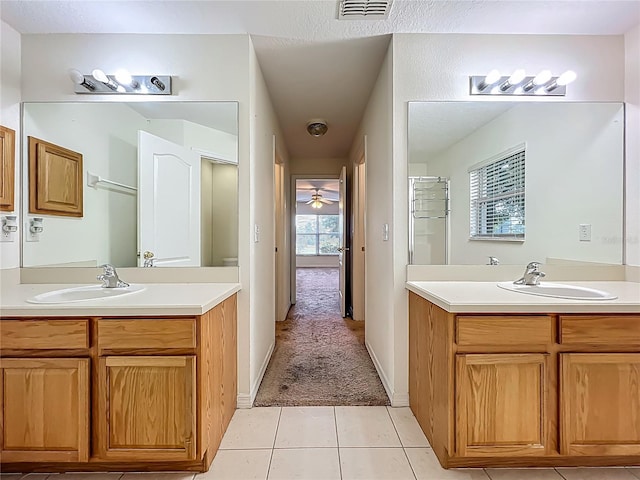 36730 Oconee Ave, Eustis, FL 32736 - full bathroom with two vanities, plenty of natural light, and tile patterned flooring