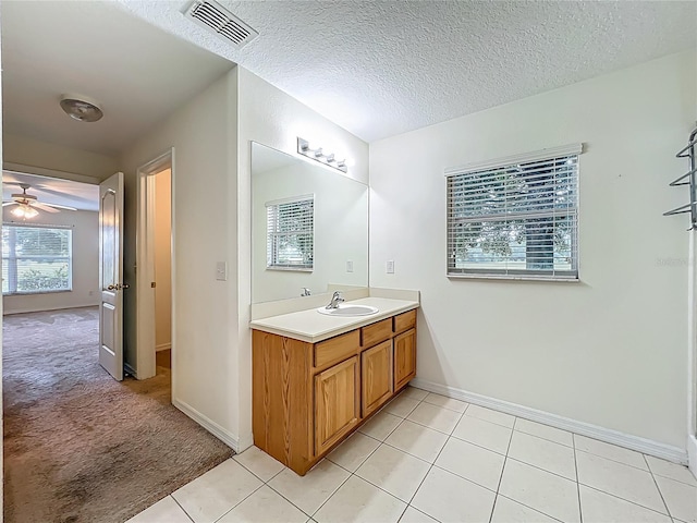 36730 Oconee Ave, Eustis, FL 32736 - bathroom featuring vanity, tile patterned flooring, ceiling fan, and a textured ceiling