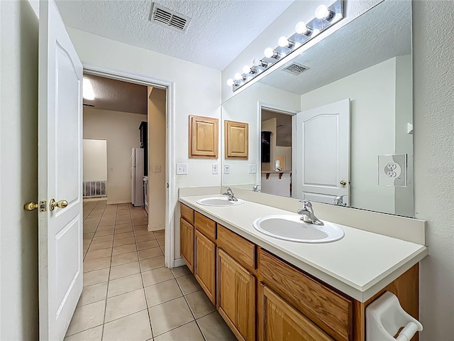 36730 Oconee Ave, Eustis, FL 32736 - full bathroom featuring tile patterned floors, double vanity, and a textured ceiling