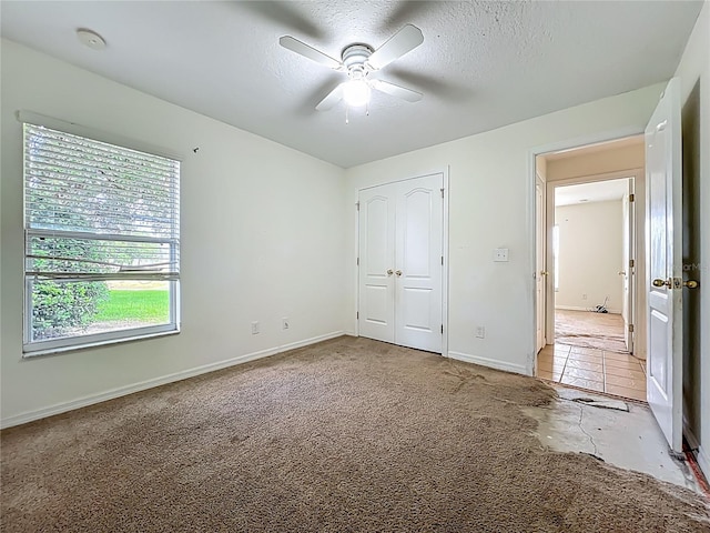 36730 Oconee Ave, Eustis, FL 32736 - unfurnished bedroom featuring light colored carpet, a closet, ceiling fan, and a textured ceiling