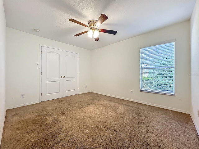 36730 Oconee Ave, Eustis, FL 32736 - unfurnished bedroom with carpet, a closet, a ceiling fan, and a textured ceiling