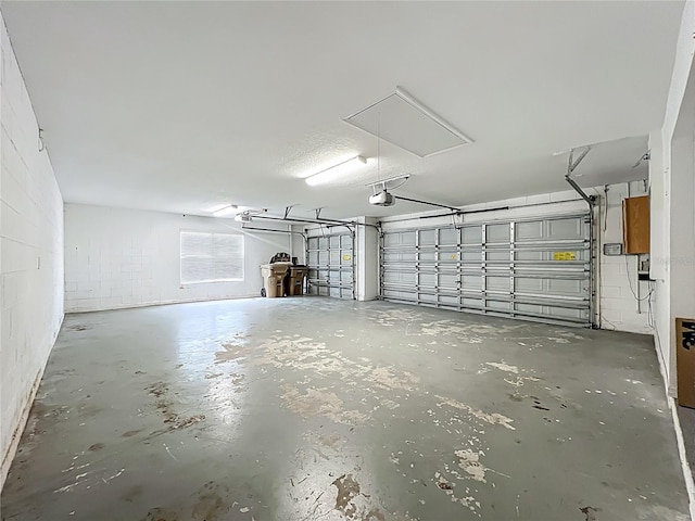 36730 Oconee Ave, Eustis, FL 32736 - garage featuring a garage door opener and concrete block wall