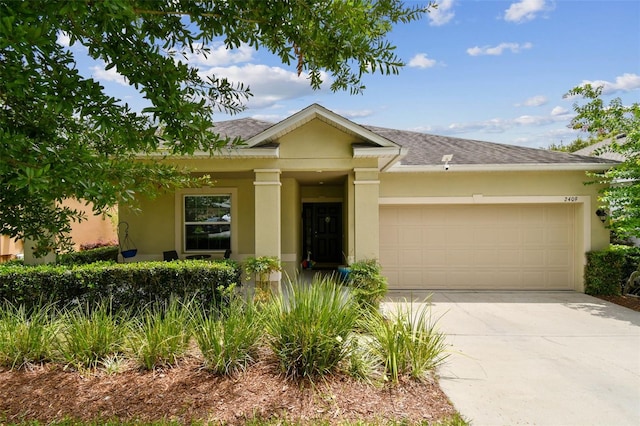 2409 Martins Run, Tavares, FL 32778 - view of front of house featuring stucco siding, an attached garage, concrete driveway, and roof with shingles