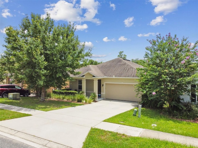 2409 Martins Run, Tavares, FL 32778 - ranch-style home featuring an attached garage, concrete driveway, a front lawn, and stucco siding