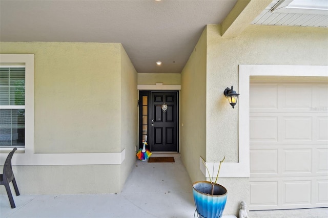 2409 Martins Run, Tavares, FL 32778 - view of exterior entry with a garage and stucco siding