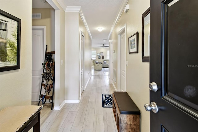 2409 Martins Run, Tavares, FL 32778 - hallway featuring crown molding and light wood-style flooring