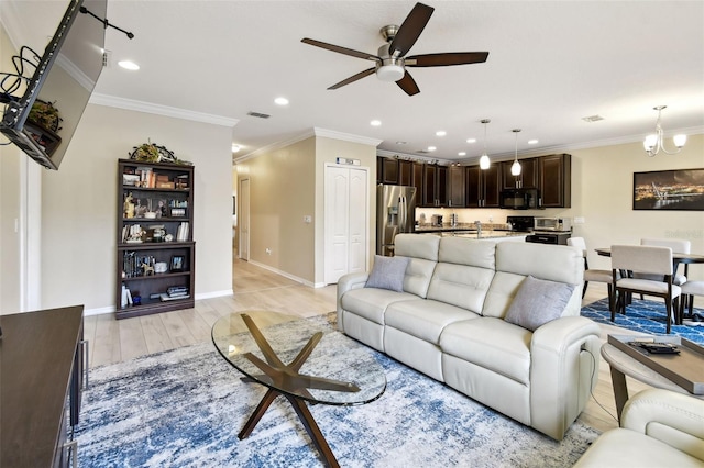 2409 Martins Run, Tavares, FL 32778 - living room with ceiling fan, recessed lighting, light wood-style flooring, ornamental molding, and a chandelier