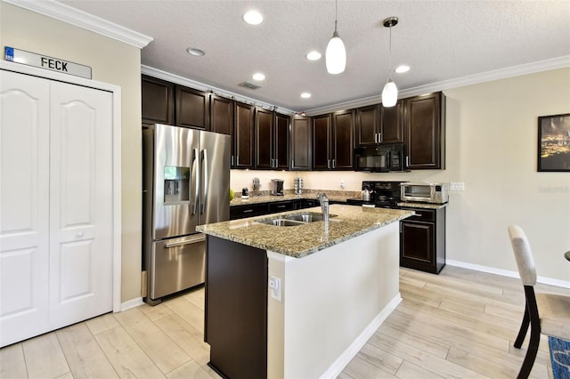 2409 Martins Run, Tavares, FL 32778 - kitchen featuring black appliances, crown molding, light stone countertops, light wood-type flooring, and hanging light fixtures