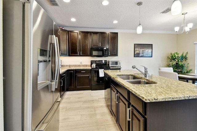 2409 Martins Run, Tavares, FL 32778 - kitchen featuring black appliances, a center island with sink, hanging light fixtures, recessed lighting, and a textured ceiling