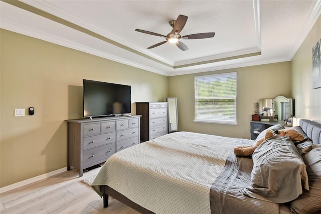 2409 Martins Run, Tavares, FL 32778 - bedroom with a tray ceiling, light wood-style flooring, a ceiling fan, and crown molding