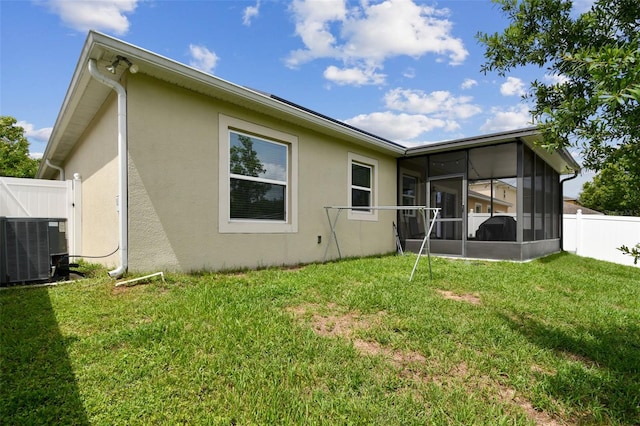 2409 Martins Run, Tavares, FL 32778 - back of house with stucco siding and a sunroom