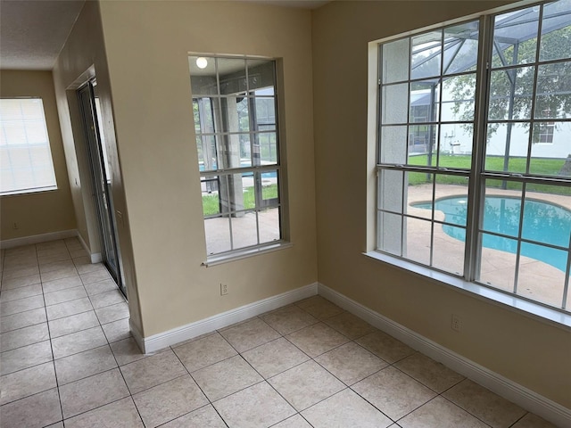 14508 Cedar Branch Way, Orlando, FL 32824 - empty room with light tile patterned floors, healthy amount of natural light, and baseboards