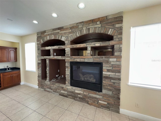 14508 Cedar Branch Way, Orlando, FL 32824 - detailed view of baseboards, a sink, recessed lighting, and a fireplace