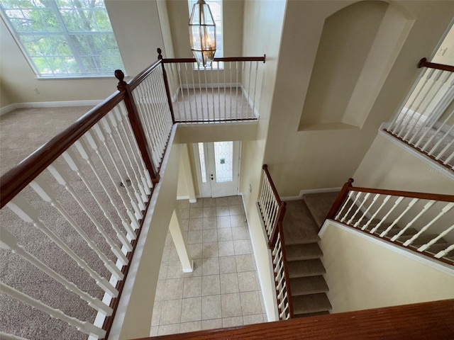 14508 Cedar Branch Way, Orlando, FL 32824 - stairway featuring baseboards, carpet, and tile patterned floors