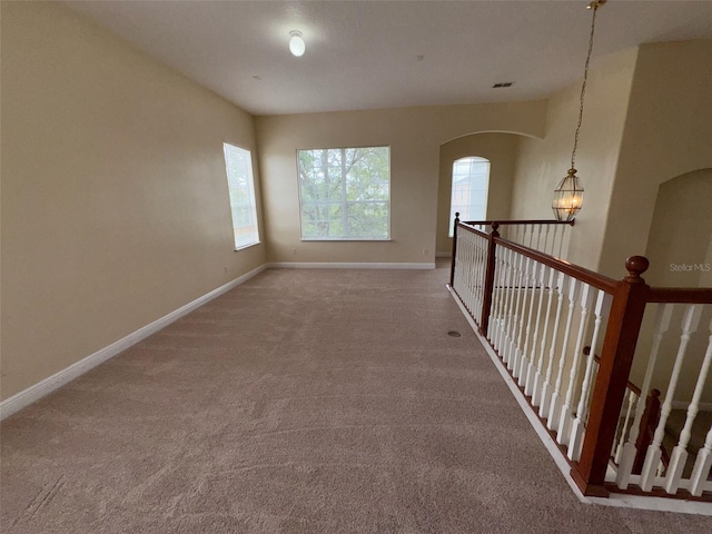 14508 Cedar Branch Way, Orlando, FL 32824 - corridor featuring carpet flooring, arched walkways, and baseboards