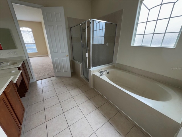14508 Cedar Branch Way, Orlando, FL 32824 - full bathroom with double vanity, a bath, tile patterned flooring, and a stall shower
