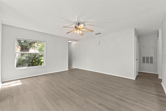 5436 E Michigan St Unit 7, Orlando, FL 32812 - spare room featuring wood finished floors, a ceiling fan, and a textured ceiling