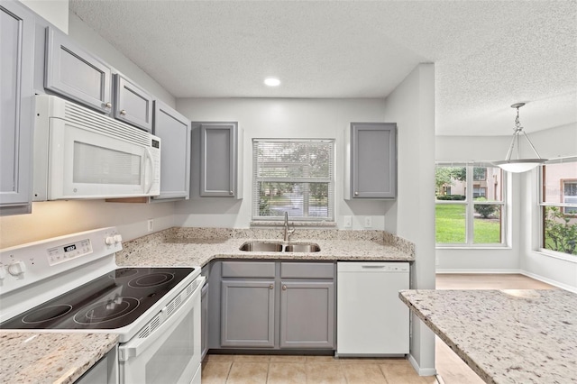 5436 E Michigan St Unit 7, Orlando, FL 32812 - kitchen featuring white appliances, gray cabinets, a textured ceiling, light stone countertops, and pendant lighting