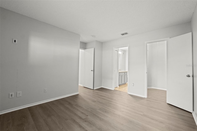 5436 E Michigan St Unit 7, Orlando, FL 32812 - unfurnished room featuring wood finished floors and a textured ceiling