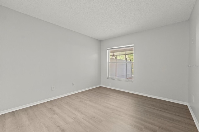 5436 E Michigan St Unit 7, Orlando, FL 32812 - spare room featuring wood finished floors and a textured ceiling