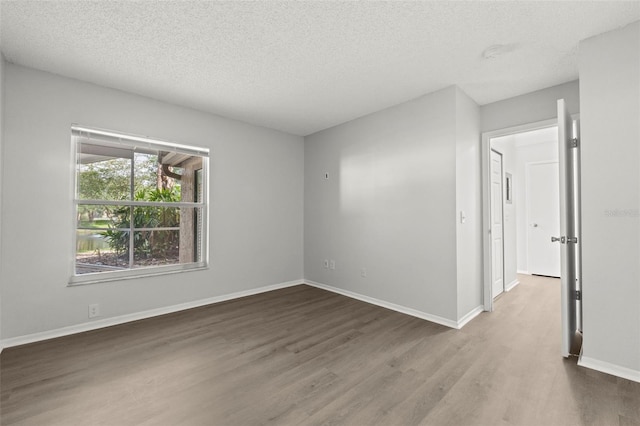 5436 E Michigan St Unit 7, Orlando, FL 32812 - empty room with wood finished floors and a textured ceiling