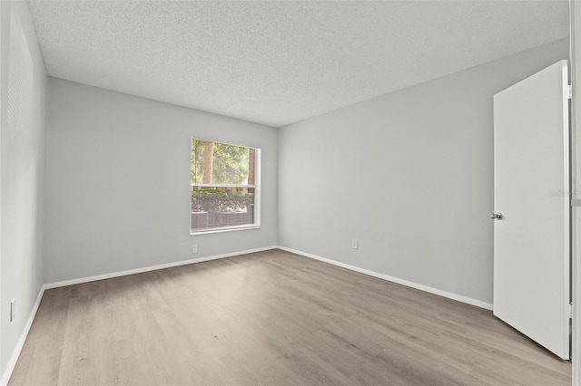 5436 E Michigan St Unit 7, Orlando, FL 32812 - spare room featuring wood finished floors and a textured ceiling