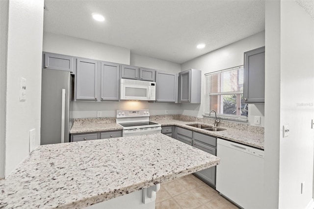 5436 E Michigan St Unit 7, Orlando, FL 32812 - kitchen featuring white appliances, gray cabinets, recessed lighting, light tile patterned flooring, and light stone countertops