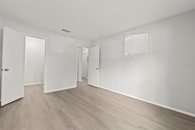 5436 E Michigan St Unit 7, Orlando, FL 32812 - unfurnished bedroom featuring a walk in closet, wood finished floors, and a closet