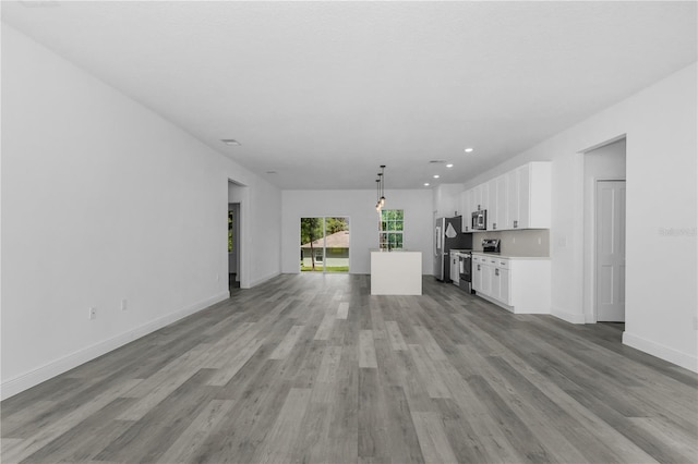 9419 N Jackson Way, Citrus Springs, FL 34434 - unfurnished living room featuring light wood-type flooring, baseboards, and recessed lighting
