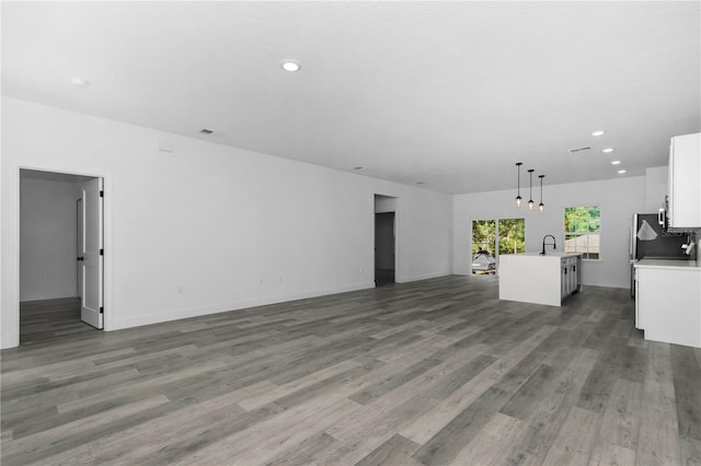9419 N Jackson Way, Citrus Springs, FL 34434 - unfurnished living room with wood finished floors, recessed lighting, and baseboards