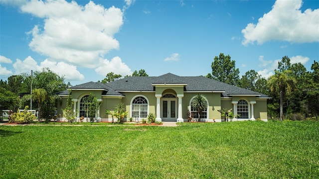 19951 Quinlan St, Orlando, FL 32833 - view of front of property featuring french doors, stucco siding, and a front lawn