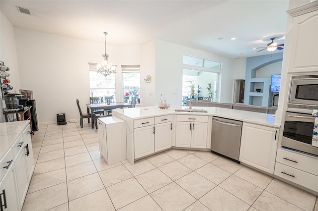 19951 Quinlan St, Orlando, FL 32833 - kitchen with appliances with stainless steel finishes, light countertops, light tile patterned floors, a chandelier, and recessed lighting