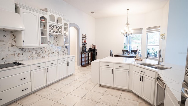 19951 Quinlan St, Orlando, FL 32833 - kitchen with custom range hood, black electric stovetop, a chandelier, tasteful backsplash, and light tile patterned floors