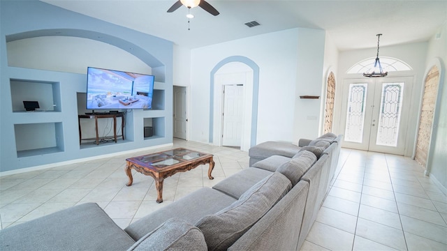 19951 Quinlan St, Orlando, FL 32833 - tiled living area featuring arched walkways, built in features, a ceiling fan, french doors, and a chandelier