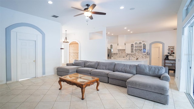 19951 Quinlan St, Orlando, FL 32833 - living room with arched walkways, a ceiling fan, light tile patterned flooring, and recessed lighting