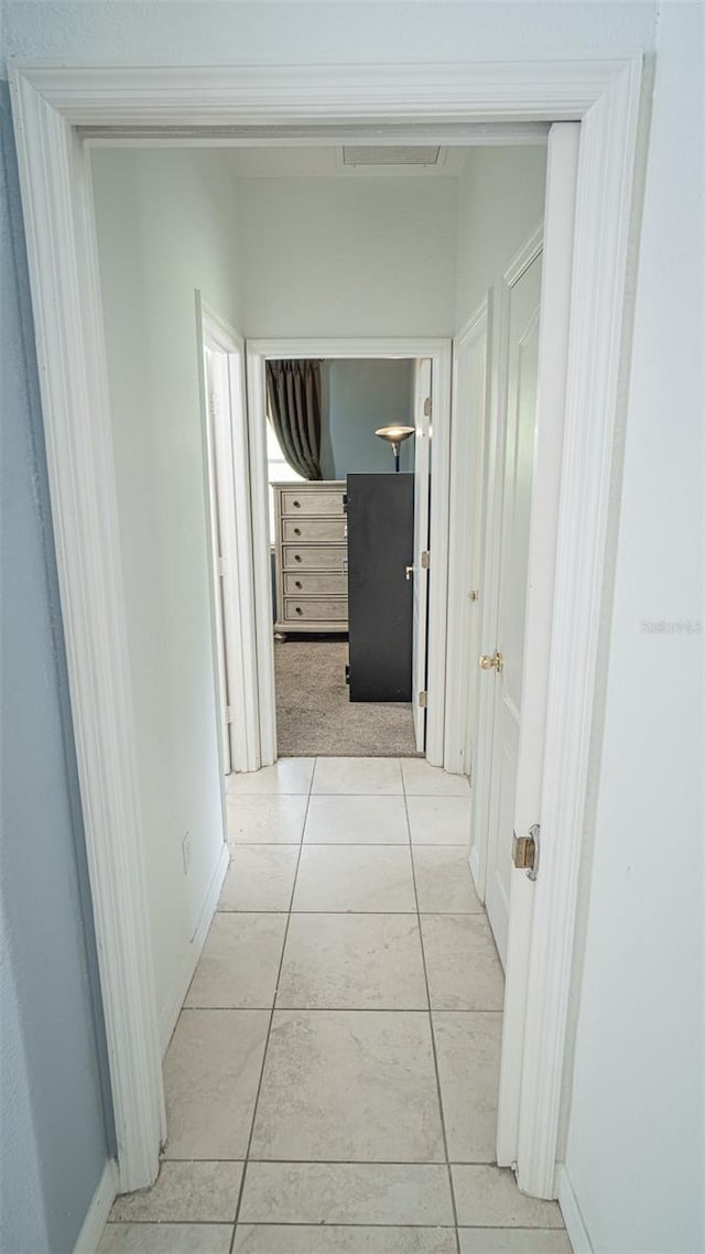 19951 Quinlan St, Orlando, FL 32833 - hallway with light tile patterned floors and baseboards