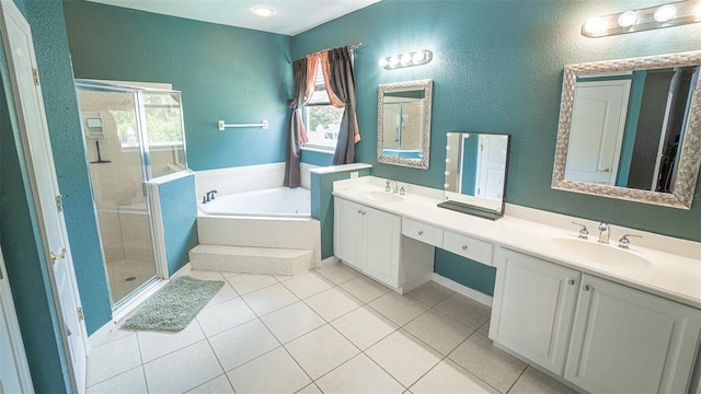 19951 Quinlan St, Orlando, FL 32833 - bathroom featuring a shower stall, a garden tub, double vanity, tile patterned flooring, and a textured wall