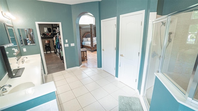 19951 Quinlan St, Orlando, FL 32833 - full bathroom with a stall shower, double vanity, a spacious closet, and tile patterned flooring