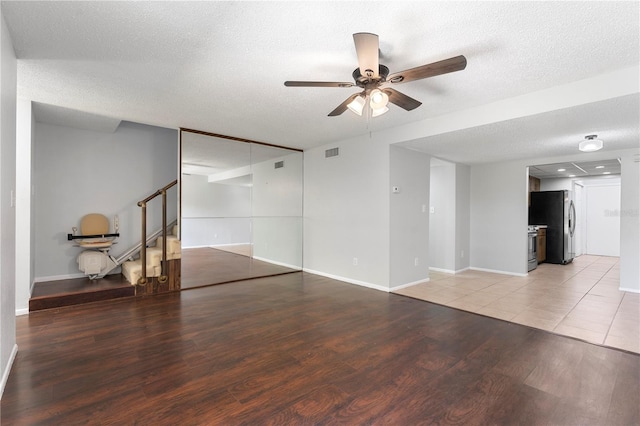 818 Park Lake Cir Unit 10, Maitland, FL 32751 - spare room with ceiling fan, light wood-type flooring, a textured ceiling, and stairs
