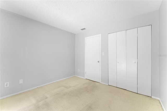 818 Park Lake Cir Unit 10, Maitland, FL 32751 - unfurnished bedroom with light carpet, a closet, and a textured ceiling