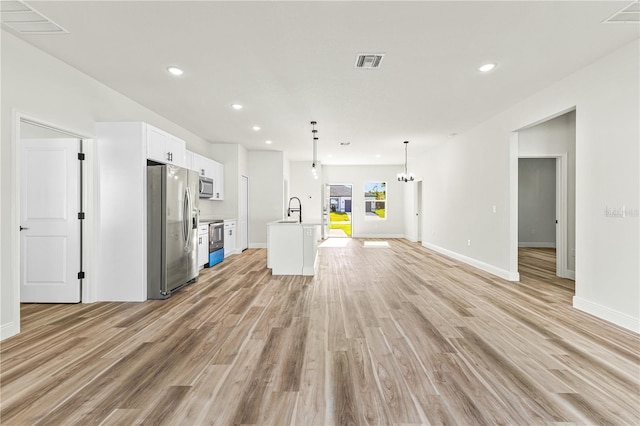 178 Marion Oaks Ln, Ocala, FL 34473 - unfurnished living room featuring a sink, light wood-style flooring, recessed lighting, baseboards, and a chandelier