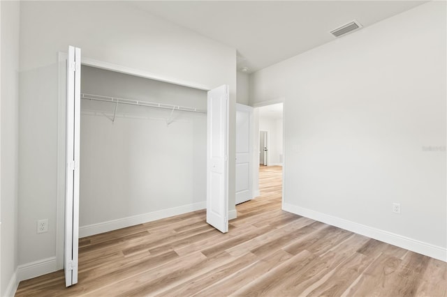 178 Marion Oaks Ln, Ocala, FL 34473 - unfurnished bedroom with light wood finished floors, a closet, and baseboards